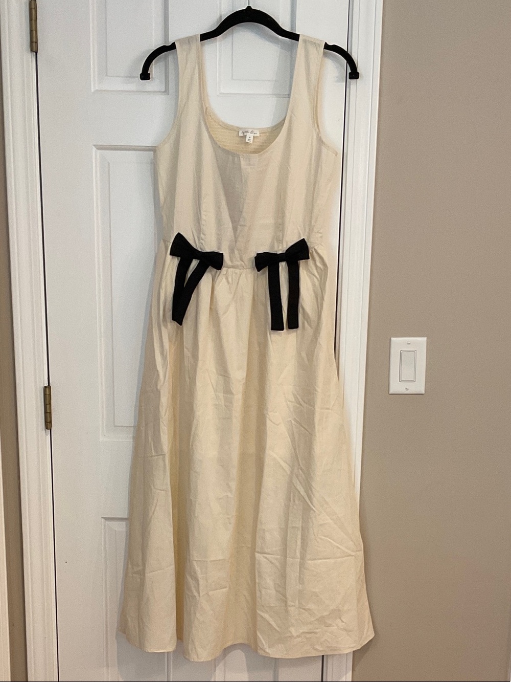 Sleeveless Cream Maxi Dress with Black Bow Accents